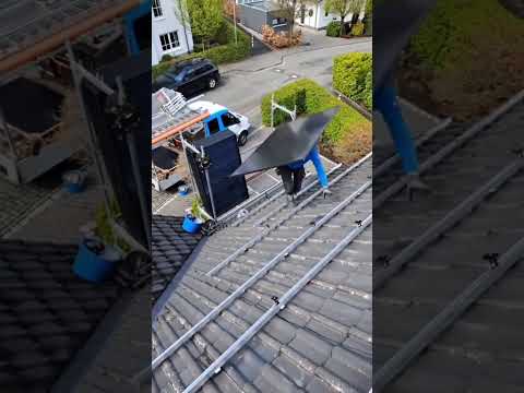 On Site! Workers Hauling Solar Panels for Residential Rooftop Installation