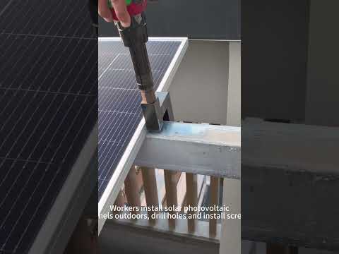 Workers are drilling holes and installing screws in solar photovoltaic panels outdoors