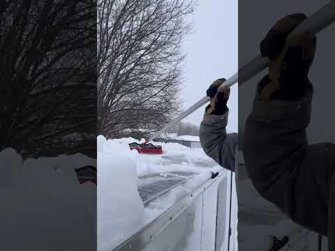 Cleaning snow from solar panels on a trailer